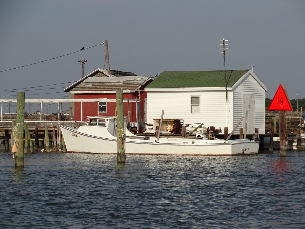 A boat in the water near a dock.