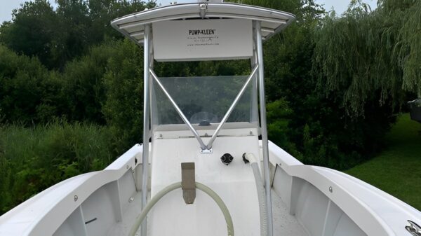 A boat with the top open and water hose attached.