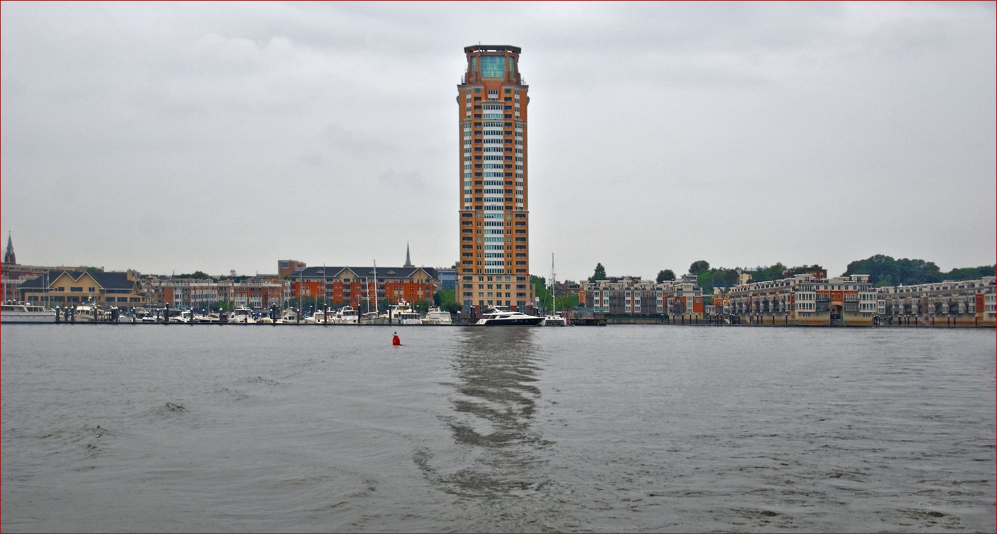 A large building on the shore of a body of water.