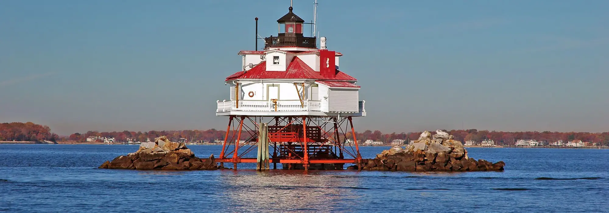 Thomas-Point-lighthouse A lighthouse sitting on top of a platform in the water.