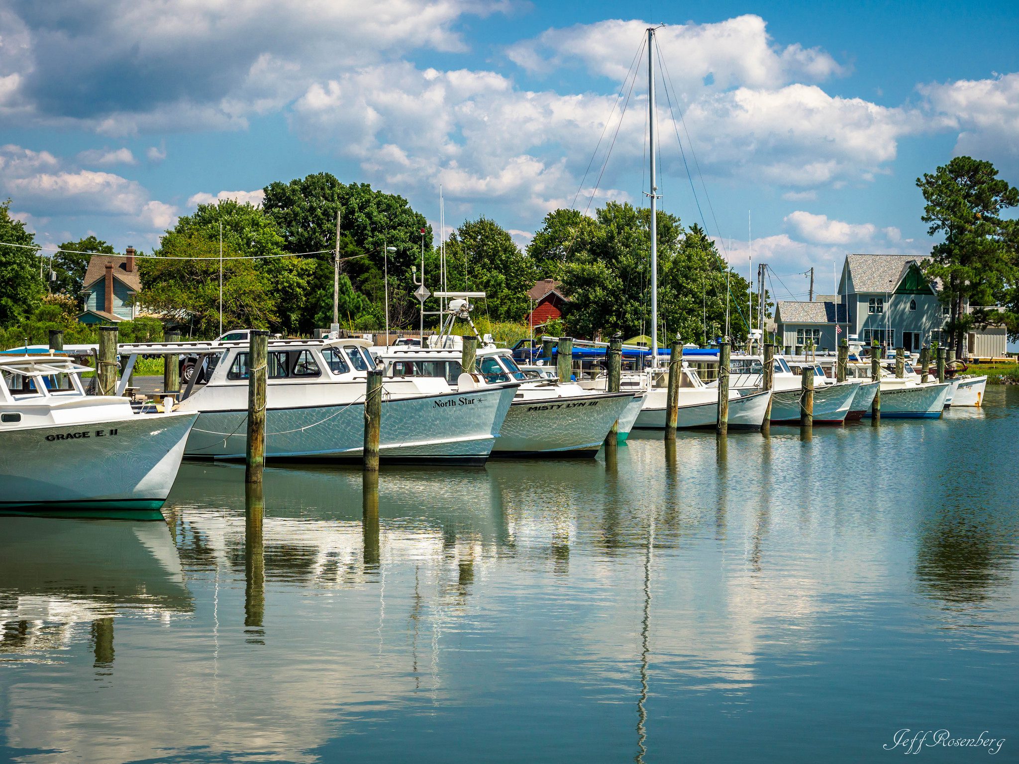 A group of boats docked in the water.
