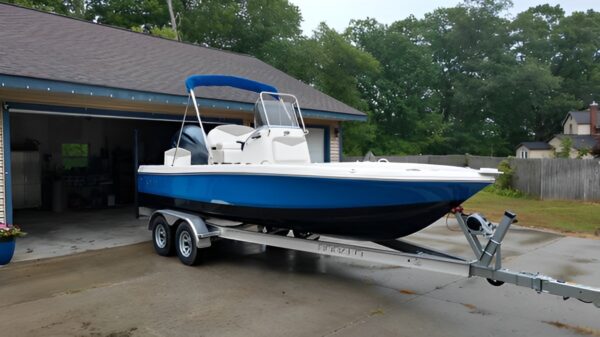 A boat is parked in the back of a trailer.