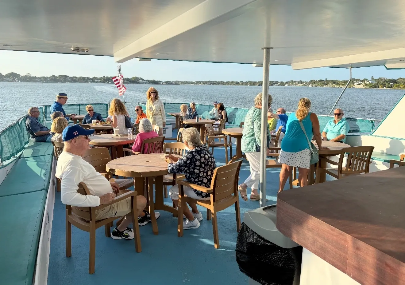 A Group Of People Gathered On A Deck